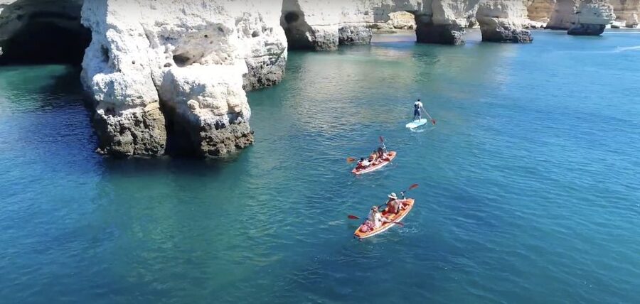 Benagil: Caves, Coves & Secret Beaches Guided Kayaking Tour - Benagil Beach and the first cave views: where teal water meets limestone walls