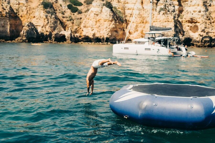 From Lagos: 2.5-Hour Guided Coastal Boat Tour & Grotto Visit - Swim Stop Reality Check: Atlantic Water, Aqua Trampoline, and a Complimentary Drink