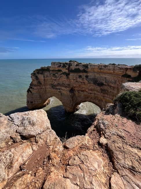 Guided hiking tour on the Seven Hanging Valleys Trail - Praia do Carvalho, a tunnel walk and shell in limestone