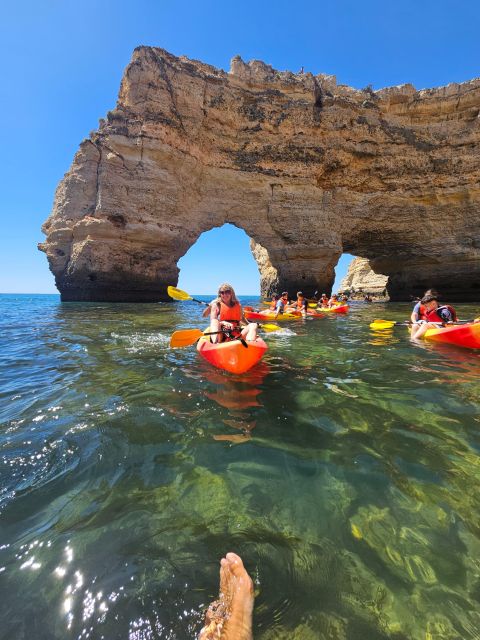 Lagoa: Benagil Cave and Marinha Beach Guided Kayaking Tour - Paddling from the cave toward Marinha Beach’s golden arches