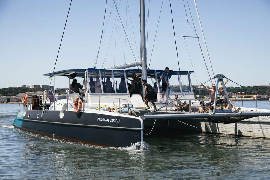 Lisbon: Catamaran Boat Party with Music, Open Bar & Dives - Meeting at Doca de Santo Amaro, door 3 (and why being early matters)