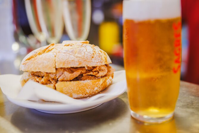 Lisbon Small-Group Portuguese Food and Wine Tour - Rossio Square and codfish cake with vinho verde