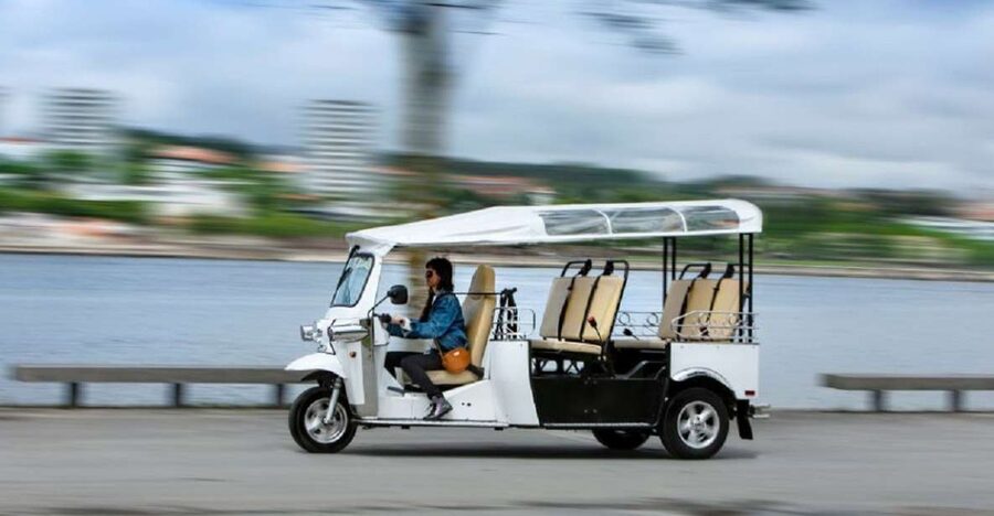 Porto: Private Sightseeing Tour by Electric Tuk Tuk - Crossing the Douro on Ponte Luís I and the Palácio da Bolsa merchant story